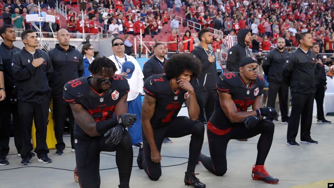 FILE - San Francisco 49ers outside linebacker Eli Harold (58), quarterback Colin Kaepernick (7) and safety Eric Reid (35) kneel during the national anthem before an NFL football game Oct. 6, 2016.