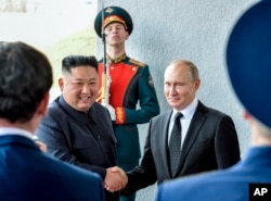 Presiden Rusia Vladimir Putin, kanan, dan pemimpin Korea Utara Kim Jong Un berjabat tangan saat pertemuan mereka di Vladivostok, Rusia, pada 25 April 2019. (Foto: via AP)