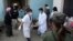 Medical staff at the Laiza hospital carry a man on a stretcher after he was injured during an artillery attack by the Burmese military in the town of Laiza, January 14, 2013. 