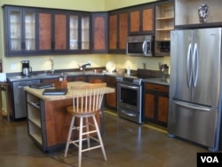 A custom kitchen in the Hardwood Artisans showroom. (J. Taboh/VOA)