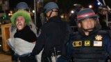 Police make an arrest as they face-off with pro-Palestinian students after destroying part of the encampment barricade on the campus of the University of California, Los Angeles (UCLA) in Los Angeles, California, early on May 2, 2024.