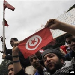 Tunisian demonstrators shout slogans against President Zine El Abidine Ben Ali in Tunis, January 14, 2011
