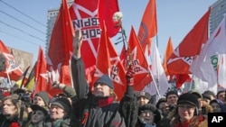 Opposition protesters with their flags shout anti-Putin's slogans as they gathered in the center of Moscow during a rally, Saturday, March 10, 2012.