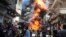 Residents run from a fire at a gasoline and oil shop in Aleppo's Bustan Al-Qasr neighborhood. Witnesses said the fire was caused by a bullet fired by a sniper loyal to Syrian President Bashar al-Assad at the Karaj al-Hajez crossing, a passageway separatin