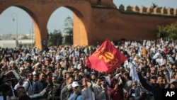 Protesters wave a flag commemorating the Feb. 20 Moroccan Arab Spring movement, during a demonstration in Rabat, Morocco, Feb. 20, 2019.