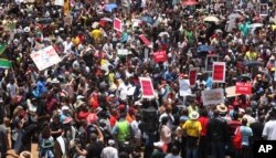 FILE - Hundreds of demonstrators gather at the end of a protest march into Johannesburg, Dec. 16, 2015. The protesters were calling for President Jacob Zuma to be removed.