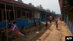 This photo taken on May 21, 2020 shows children playing at a camp for internally displaced people (IDP) near Myitkyina in northern Kachin state, where civilians have sought refuge in the wake of ongoing conflict involving rebel groups and the Myanmar mili