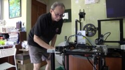 William Alvisse is using eight 3-D printers at his home to make face shields for frontline medical workers across Malaysia. (VOA/Dave Grunebaum)