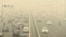 Traffic moves on a road enveloped by toxic smog in New Delhi, India, on Nov. 3, 2023.