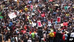 Hundreds of demonstrators gather at the end of a protest march across the Nelson Mandela bridge into Johannesburg, Dec. 16, 2015. The protesters were calling for President Jacob Zuma to be removed.