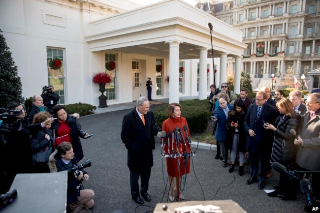 House Minority Leader Nancy Pelosi of Calif., right, accompanied by Senate Minority Leader Sen. Chuck Schumer of N.Y., left, speaks to members of the media outside the West Wing of the White House in Washington, Tuesday, Dec. 11, 2018, following a meeting with President Donald Trump.