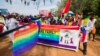 People holding rainbow flags take part in the Gay Pride parade in Entebbe, Aug. 8, 2015. 