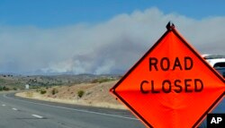 A fire burns near Mayer, Arizona, June 28, 2017, as seen from Spring Valley, Arizona.