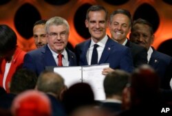 International Olympic Committee President Thomas Bach (IOC), left, poses with Los Angeles Mayor Eric Garrett at the end of an IOC session in Lima, Peru, Sept. 13, 2017.
