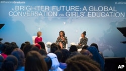 First lady Michelle Obama, flanked by actress Yara Shahidi (R) and Glamour Magazine Editor in Chief Cindi Leive, participates in Glamour's “A Brighter Future: A Global Conversation on Girls' Education,” in celebration of International Day of the Girl and Let Girls Learn, Oct. 11, 2016, at the Newseum in Washington.