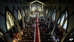 FILE - The Catholic Church officiates a reconciliation mass, which seeks to bring together all sectors of the community following the Church sex abuse scandal, at the San Mateo cathedral of Osorno, Chile, June 17, 2018. 