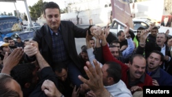 Ahmed Safadi, who won a seat in parliamentary elections, celebrates with his supporters in Amman, Jordan, January 24, 2013.