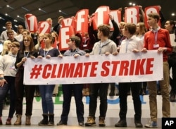 Polish teenagers stage a protest in the U.N. climate conference venue on the last days of talks to urge negotiators from almost 200 countries to reach an agreement on ways of keeping global warming in check, in Katowice, Poland, Dec. 14, 2018.