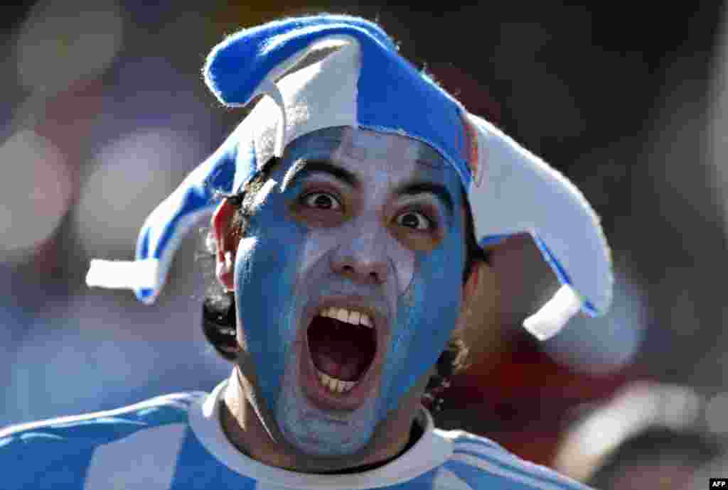 An Argentina fan cheers prior to a Round of 16 football match between Argentina and Switzerland at Corinthians Arena in Sao Paulo, Brazil, during the 2014 FIFA World Cup.