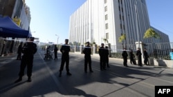 Policemen in riot gear guard at checkpoint on road near a courthouse where ethnic Uighur academic Ilham Tohti's trial is taking place in Urumqi, Xinjiang Uighur Autonomous Region, Sept. 17, 2014.