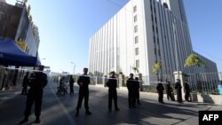 Chinese police seal off the road leading to the Urumqi Intermediate People's court as the trial of Ilham Tohti, a former economics professor at a university in Beijing, begins in Urumqi, farwest China's Xinjiang region, September 17, 2014.