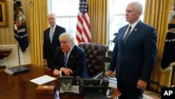President Donald Trump, flanked by Health and Human Services Secretary Tom Price, left, and Vice President Mike Pence, meets with reporters regarding the health care overhaul bill at the White House in Washington, March 24, 2017.