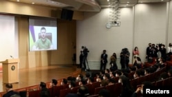 Ukrainian President Volodymyr Zelenskiy addresses South Korean parliament via video in Seoul, South Korea, on April 11, 2022. An active-duty South Korean marine who reportedly tried to reach Ukraine has been arrested after arriving back home, Seoul’s military said on Monday.