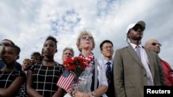 People watch as U.S. President Barack Obama, Defense Secretary Ash Carter and Joint Chiefs Chair Gen. Joseph Dunford take part in a ceremony marking the 15th anniversary of the 9/11 attacks at the Pentagon in Washington, Sept. 11, 2016. 