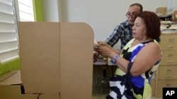 A Puerto Rican resident votes during the fifth referendum on the island's status, in San Juan, Puerto Rico, June 11, 2017.