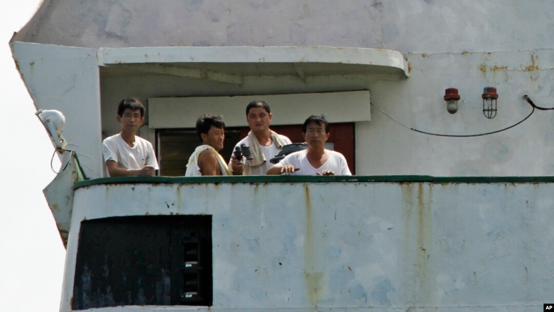 North Korean sailors look out from the deck of their cargo ship Chong Chon Gang in Sherman Bay near Colon City, Panama, Wednesday, Feb. 12, 2014