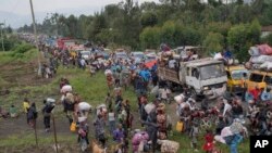 FILE - Thousands who are fleeing the ongoing conflict between government forces and M23 rebels reach the entrance the Democratic Republic of Congo eastern city of Goma February 7, 2024.