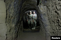 Afghan Special Forces inspect inside a cave which was used by suspected Islamic State militants at the site where a MOAB, or ''mother of all bombs'', struck the Achin district of the eastern province of Nangarhar, Afghanistan April 23, 2017.