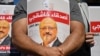 FILE - Friends of slain Saudi journalist Jamal Khashoggi hold posters bearing his picture as they attend an event marking the second anniversary of his assassination in front of Saudi Arabia's Istanbul consulate, Oct. 2, 2020. 