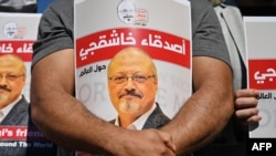 Friends of slain Saudi journalist Jamal Khashoggi hold posters bearing his picture as they attend an event marking the second-year anniversary of his assassination in front of Saudi Arabia Istanbul Consulate, on Oct. 2, 2020. 