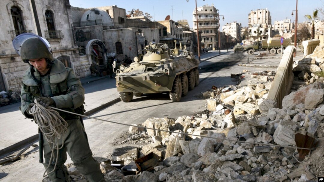 This photo made from the footage taken from Russian Defense Ministry official website on Feb. 4, 2017, claims to show a Russian sapper looking for mines in a street in Aleppo, Syria.