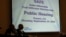 FILE - Mike Stoker, regional administrator of US EPA and Jonathan Morrison of NHTSA listen to speakers during the first of three public hearings on the Trump administration's proposal to roll back car-mileage standards in a region with some of the worst air pollution.