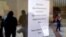 People who lost their jobs are reflected in the door of an Arkansas Workforce Center as they wait in line to file for unemployment following an outbreak of the coronavirus disease (COVID-19), in Fort Smith, Arkansas.