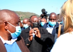 South African President Cyril Ramaphosa, visits an area in Durban, July 16, 2021 which was badly affected by unrest in the past week.