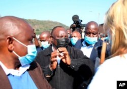 South African President Cyril Ramaphosa, visits an area in Durban, July 16, 2021 which was badly affected by unrest in the past week.
