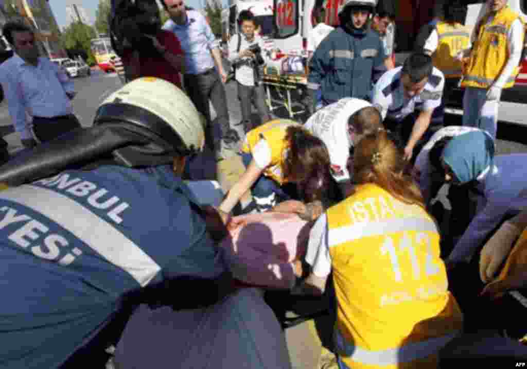 A wounded man is taken to an ambulance following a blast in Istanbul May 26, 2011. A bomb placed on an electric bicycle exploded in Istanbul on Thursday, wounding seven people, Istanbul's police chief Huseyin Capkin told reporters. He said none of the wou