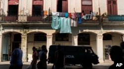 A police vehicle patrols through Old Havana, Cuba, Monday, July 12, 2021, the day after protests against food shortages and high prices amid the coronavirus crisis. 