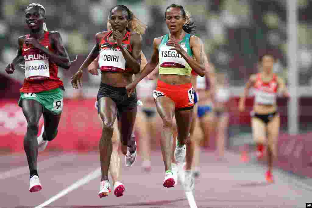 Gudaf Tsegay, of Ethiopia, right, crosses the finish line ahead of Hellen Obiri of Kenya, 2nd left, to win a heat in the women&#39;s 5,000-meter run at the 2020 Summer Olympics, Friday, July 30, 2021, in Tokyo. (AP Photo/Petr David Josek)