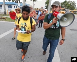Jose Luis Santiago (left) an immigration advocate, marches during a protest march in Homestead, Fla. Cinco de Mayo, a once-obscure holiday marking a 19th century-battle between Mexico and invading French forces, is being met with ambivalence by Mexican-American and Mexican immigrants. President Donald Trump’s immigration policies and rhetoric are leaving some Mexican Americans and immigrants feeling at odds with Cinco de Mayo.