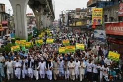 PAKISTAN -- Supporters of hardline Islamist party Tehreek-e-Labbaik Pakistan carry placards and shout slogans during a protest against the reprinting of cartoons of the Prophet Mohammad by French magazine Charlie Hebdo, in Rawalpindi, Sept. 4, 2020.