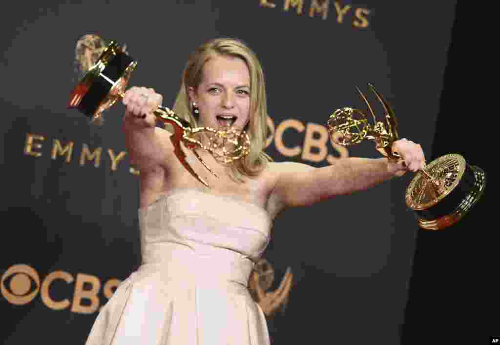 Elisabeth Moss poses in the press room with her awards for Outstanding Lead Actress in a drama series and Outstanding Drama Series for &quot;The Handmaid&#39;s Tale&quot; at the 69th Primetime Emmy Awards on Sunday, Sept. 17, 2017, at the Microsoft Theater in Los Angeles.