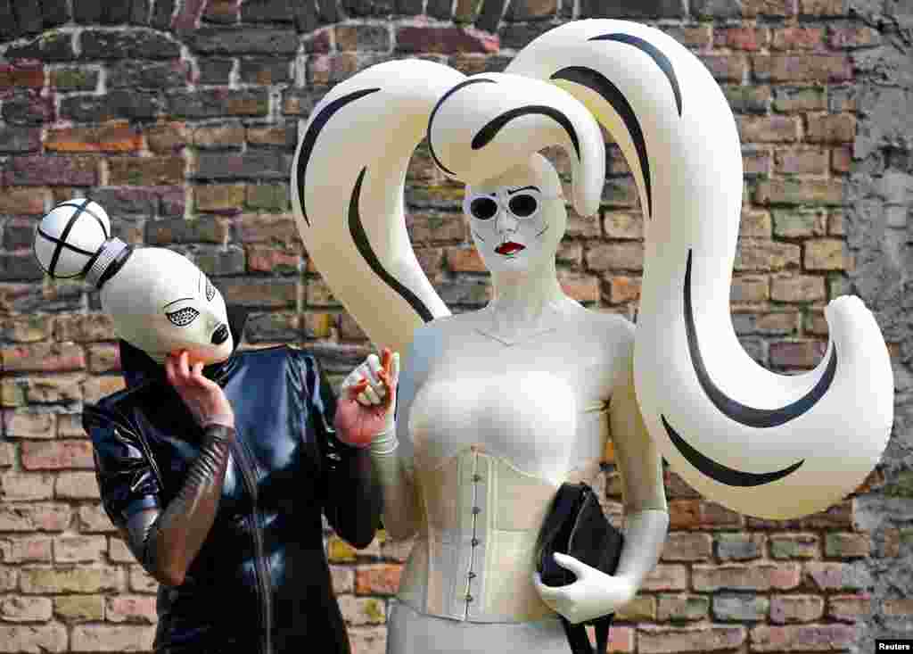 Visitors pose at the "German Fetish Ball" fair in Berlin, Germany, May 12, 2018.