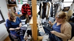 In this April 10, 2019, photo, seamstresses Sonia Genao, left, and Juana Rodrize work on coats at Pologeorgis Furs in New York.