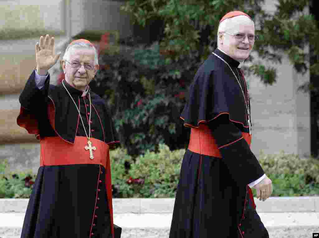 Cardinal Odilo Pedro Scherer, of Brazil, right, is followed by Cardinal Geraldo Majella Agnelo as they arrive for a meeting at the Vatican, March 8, 2013. 