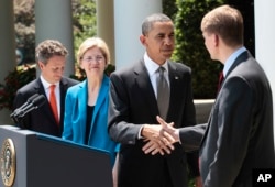 President Barack Obama shakes hands with Richard Cordray, right, after announcing the nomination of Cordray to serve as the first director of the Consumer Financial Protection Bureau, July 18, 2011, in Washington. Treasury Secretary Timothy Geithner is at left, and Elizabeth Warren, head the Consumer Financial Protection Bureau, is second from left.