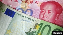 A 100 Euro banknote is placed on top of a 100 yuan banknote in this illustration taken in Beijing, November 7, 2010.
